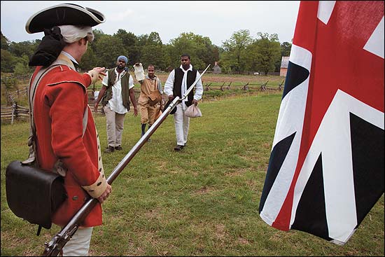 Left to right, Jason Gordon, Richard Josey, with a copy of Dunmore's proclamation, and Willie Wright approach a redcoat, here Stuart Pittman, to join the British forces and gain freedom. The prospect of enslaved blacks fighting slaveholders was meant to frighten colonists.